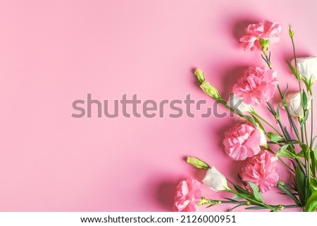 Pink rose, peonies and carnation and white flowers composition on pink pastel background, creative flat lay, copy space. Garden roses, spring summer blush floral design concept.