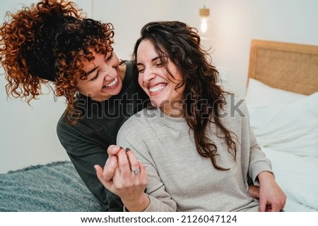 Happy gay women couple celebrating together with engagement ring in bed - Soft focus on right lesbian girl face Royalty-Free Stock Photo #2126047124