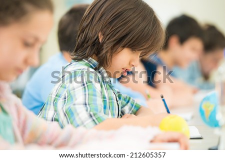 Cheerful kids learning in school classroom