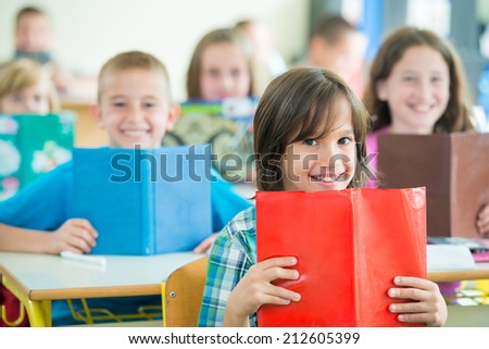 Cheerful kids learning in school classroom