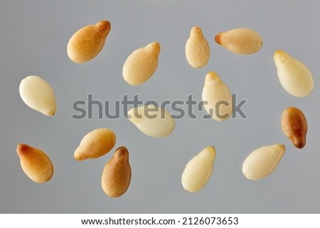 roasted sesame seeds macro on grey background, top view Royalty-Free Stock Photo #2126073653