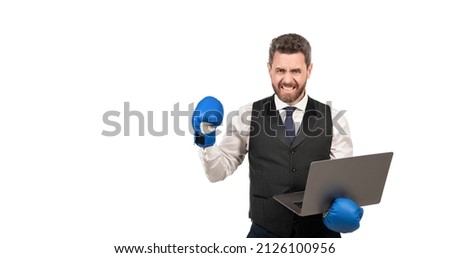 angry businessman in boxing gloves hold pc isolated on white background, copy space, cyber bullying Royalty-Free Stock Photo #2126100956