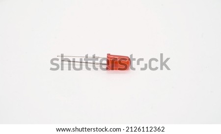 Red LED electronic component on white background isolated. Light emitting diode. DIY. Optic electric technology.