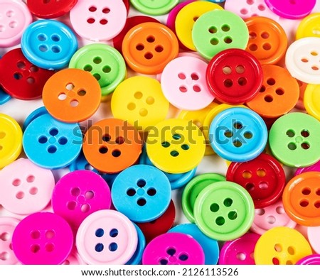 Colorful sewing buttons on background