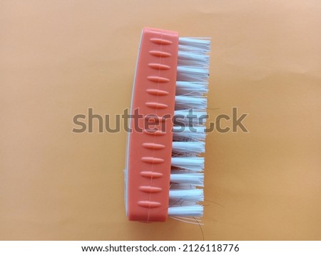 white orange washing brush with plastic material is in the store