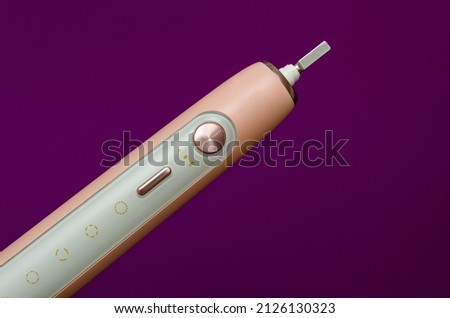 sonic electric toothbrush without nozzle on purple background