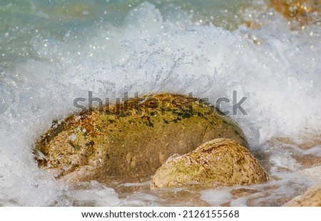 texture for desktop and screen saver, ocher color stone in contrast with blue and white water