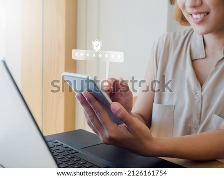 Two steps authentication concept. Virtual safety shield icon while access on phone with laptop for validate password, Identity verification, cybersecurity with biometrics authentication technology. Royalty-Free Stock Photo #2126161754