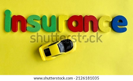 Top view of text of Insurance and model car with yellow background. Conceptual