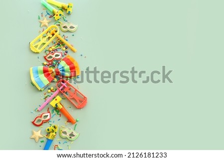 Purim celebration concept (jewish carnival holiday) over green background