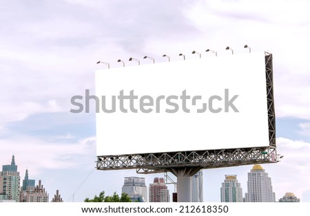 large blank billboard on road with city view background.