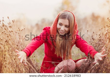 Portrait of beautiful girl with scarf in autumn nature