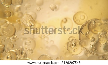 Oil Bubbles on Golden Background, Macro Shot. Royalty-Free Stock Photo #2126207543