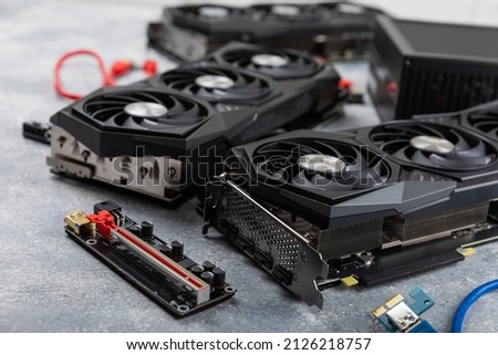Gaming video card, video card adapter on a concrete background for video games and cryptocurrency mining. Computer parts. GPU card.	
