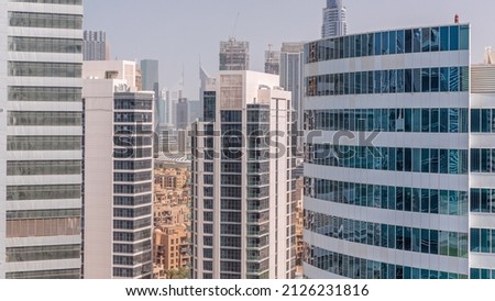 Skyscrapers in Dubai Business Bay and financial district aerial timelapse. Skyline with office towers and construction site in downtown Royalty-Free Stock Photo #2126231816