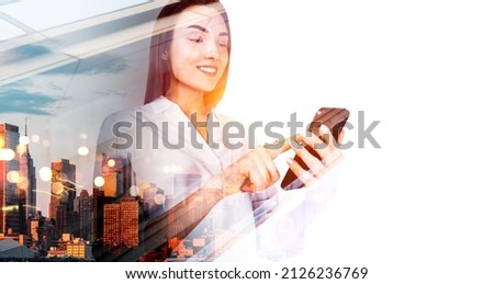 Businesswoman smiling and finger touch smartphone. Double exposure with office buildings in New York, cityscape in evening. Concept of technology and management