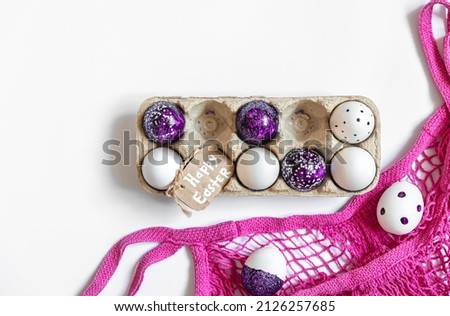 Easter background with decorative eggs tray isolated on white, flat lay.