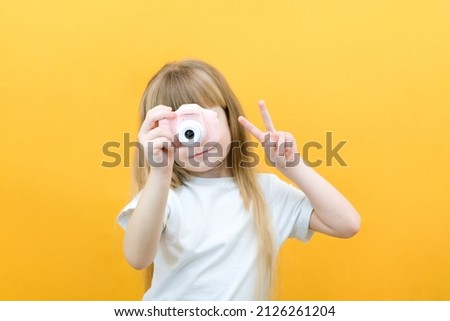 real happiness. hobby or career. beginner photographer with a camera. childhood. girl takes a picture. kid uses digital camera. happy baby photography. photography school Royalty-Free Stock Photo #2126261204