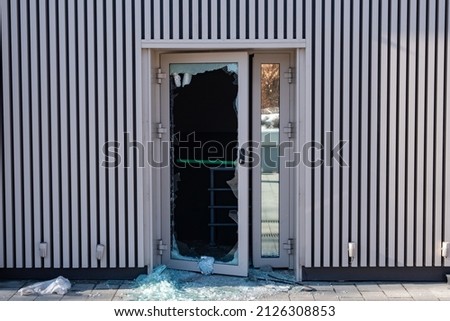 Broken glass door in shopping mall. Vandalism, burglary concept. Insurance concept. Cracked glass due to crime, robbery of shop concept. Royalty-Free Stock Photo #2126308853