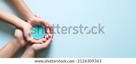 Hands holding earth, save planet, earth day, ecology environment, climate emergency action, csr social responsibility, sustainable living concept Royalty-Free Stock Photo #2126309363