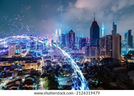 Abstract technology icons, night aerial panoramic cityscape of Kuala Lumpur, Malaysia, Asia. The concept of innovative approach to optimize international business process. Double exposure.