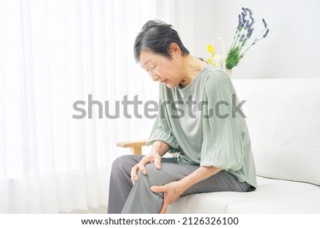 Asian woman having the joint pain Royalty-Free Stock Photo #2126326100