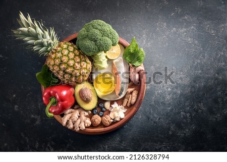 Collection of healthy food with anti-inflammatory and antioxidant on a wooden plate, immune system diet with fiber, vitamin, omega-3 and minerals, dark gray background, copy space, top view from above Royalty-Free Stock Photo #2126328794