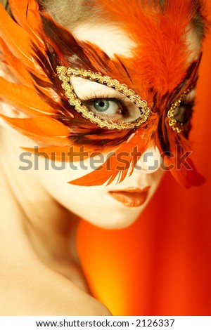 Portrait of attractive beautiful young woman wearing red carnival mask Royalty-Free Stock Photo #2126337