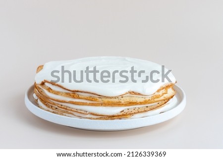 Whole vanilla crepe cake on a plate, gluten free, not decorated, mockup Royalty-Free Stock Photo #2126339369