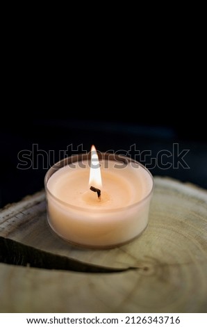 burning candle on a wooden stand. religious concept. romantic atmosphere
