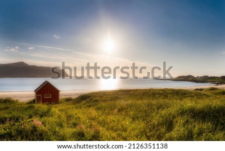 Afternoon Shot of the the Sun Setting and the Worn Hut on Beautiful Ramberg Beach, Flakstad Island, Lofoten, Norway Royalty-Free Stock Photo #2126351138