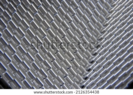 Shiny corrugated metal in the form of a wave. Forming of curved aluminum. Shiny metal like a mirror. Metal textures at an angle
