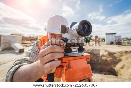 Surveyor worker with theodolite equipment at construction site Royalty-Free Stock Photo #2126357087