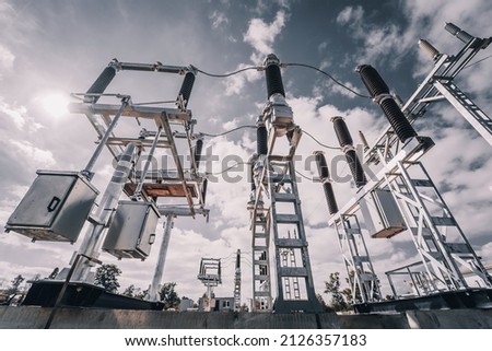 Construction of a power transmission substation on a background of grey sky Royalty-Free Stock Photo #2126357183