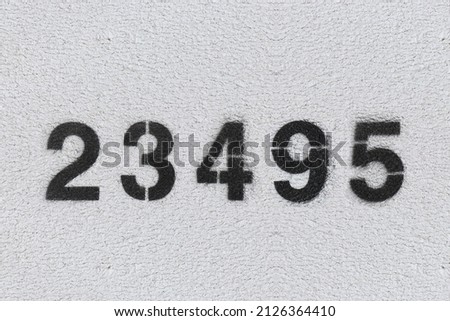 Black Number 23495 on the white wall. Spray paint.two hundred and three thousand four hundred and ninety fivetwo hundred and three thousand four hundred and ninety five