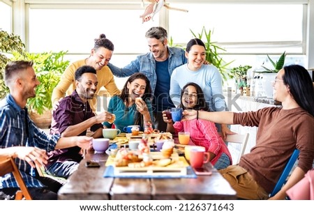 Young people drinking and eating at coffee bar - Friends talking and having fun together at fancy cafeteria - Friendship life style concept with happy guys and girls at restaurant cafe - Bright filter Royalty-Free Stock Photo #2126371643