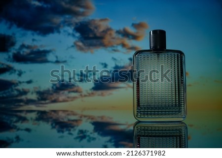 beautiful glass perfume bottle, sunset sky background