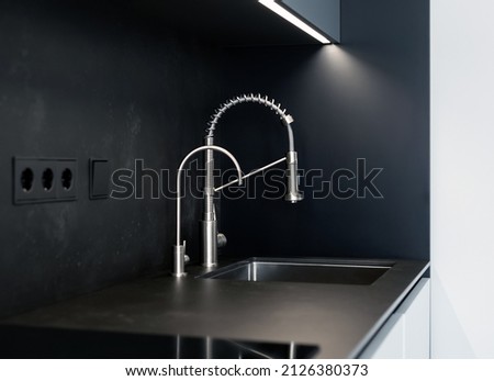 Modern kitchen washbasin with chrome faucet (water mixer) close-up. Royalty-Free Stock Photo #2126380373