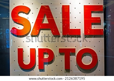 Red Sign on a shop window. Sale in a store