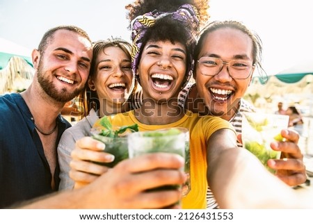 Multicultural friends having beach party on summer day - Happy teenagers holding mojito cocktails taking selfie pic outside at open terrace bar - Youth people and summertime lifestyle concept