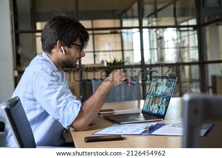 Indian corporate manager leading virtual multicultural business team work meeting workers group conference online remote video call. Company leader having distant videoconference on laptop. Royalty-Free Stock Photo #2126454962