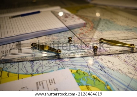 Nautical chart, parallel ruler and triangle close up detail Royalty-Free Stock Photo #2126464619