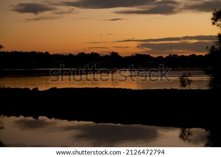 sunset red sun river reflections sky water mountain trees