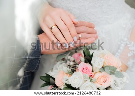 Holding wedding rings. Noble metal jewellery for married couples.Wedding ceremony and planing.Holding traditional bridal commitment jewellery.Golden ring for bride and groom.Marriage proposal exchange