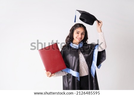 Beautiful woman university graduate wearing academic regalia with red diploma mockup isolated on white background. Royalty-Free Stock Photo #2126485595