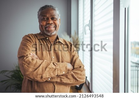 Portrait of smiling senior african american man at home near window. Portrait Of Happy Senior Man At Home. Happy mature African American man smiling Royalty-Free Stock Photo #2126493548