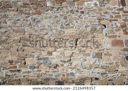Close-up of a fragment of an old natural white limestone wall. Stone wall, background, close-up texture