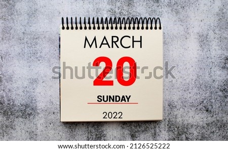 march 20. 20th day of month, calendar date. Stand for desktop calendar on beige wooden background. Concept of day of year, time planner, spring month.