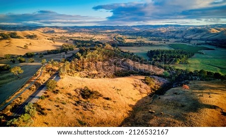 Early morning light over the hills, farmland and Goulburn River between Taggerty and Alexandra in Victoria Australia Royalty-Free Stock Photo #2126532167
