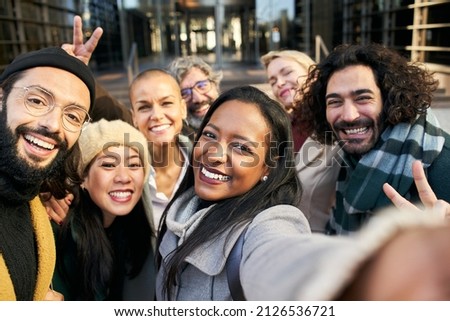 Selfie of a group of happy business people taking photo with a phone Royalty-Free Stock Photo #2126536721